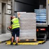 A man loading pallets in semi-truck